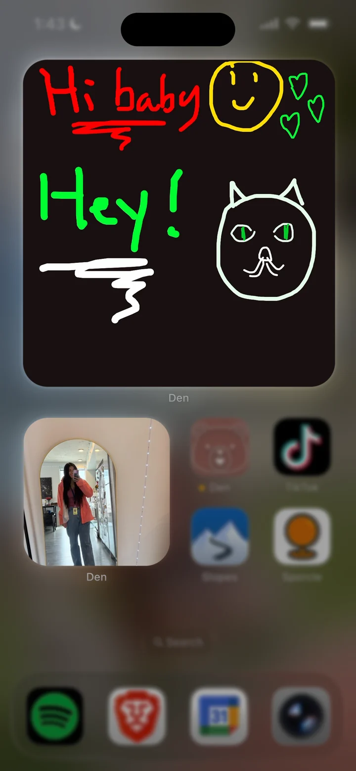 A hand-drawn doodle saying Hi baby and Hey, with a smiley, hearts, and a cat, in a large home screen widget above a small partner selfie
