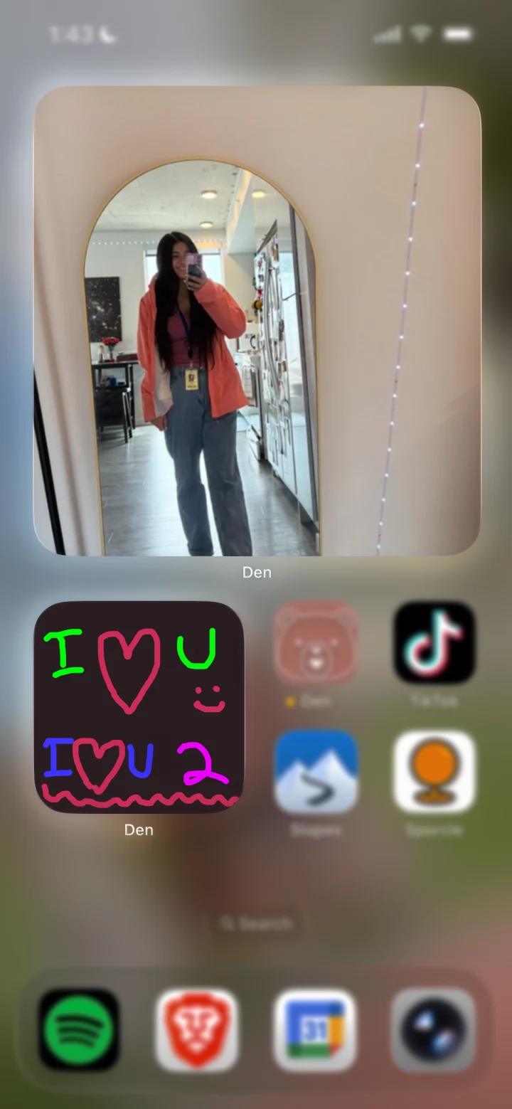A partner's selfie and a shared I love you doodle on the iPhone home screen